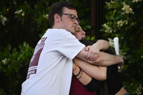 Students embrace near a Florida State University shooting scene.
