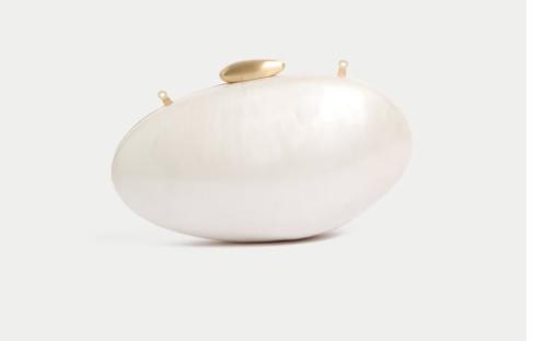 Oval white clutch with gold clasp.