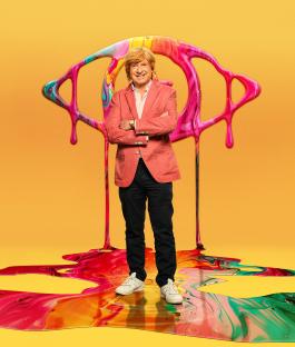 Michael Fabricant standing on a paint spill, arms crossed, in front of a large, abstract eye.