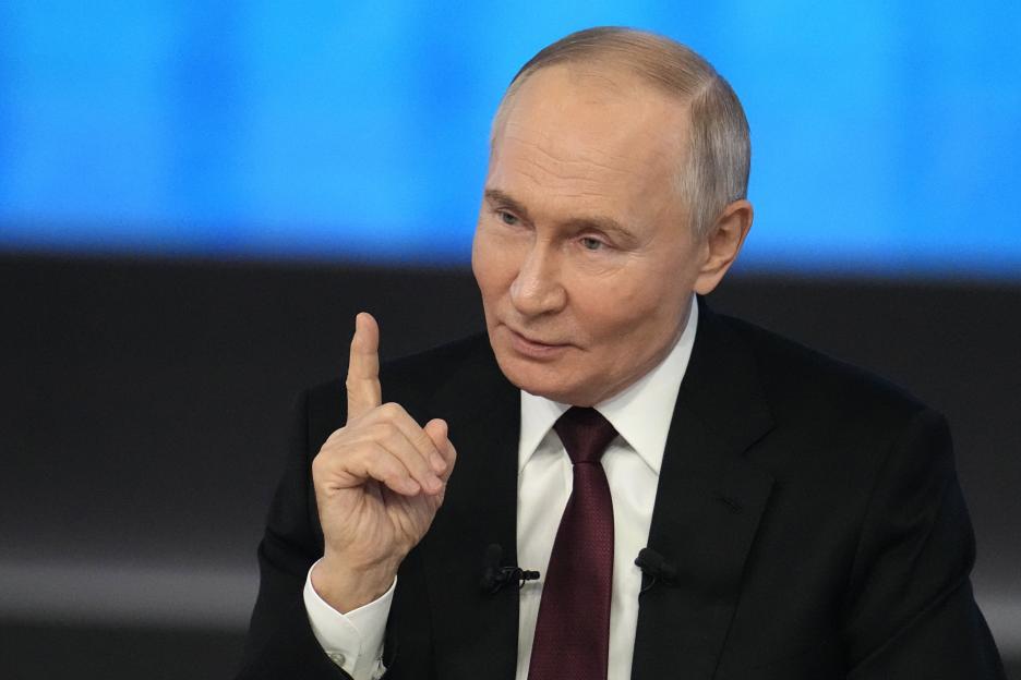 Vladimir Putin gesturing during a news conference.