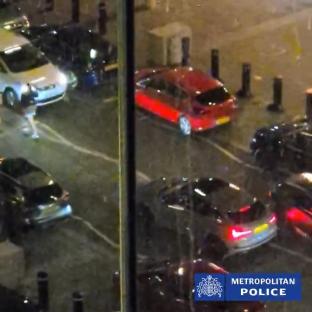 Security camera footage of a woman being struck by a car.
