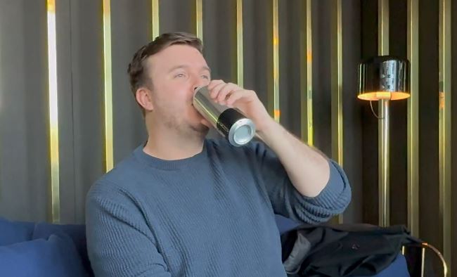 Man drinking from a self-cooling can.