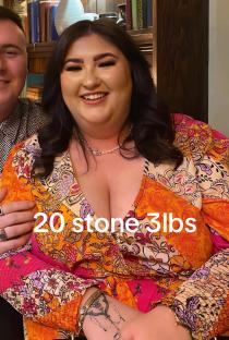Woman wearing a floral dress, weighing 20 stone 3 lbs.