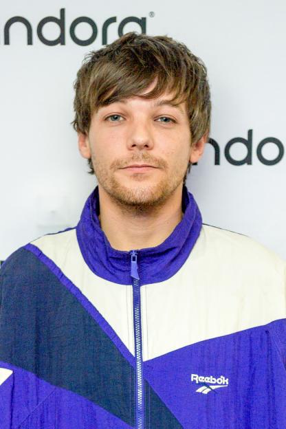 Portrait of Louis Tomlinson wearing a Reebok jacket.