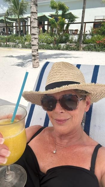 Woman on vacation enjoying a tropical drink.