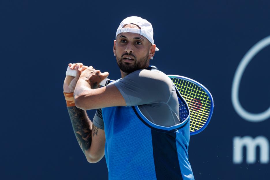 Nick Kyrgios hitting a backhand in a tennis match.