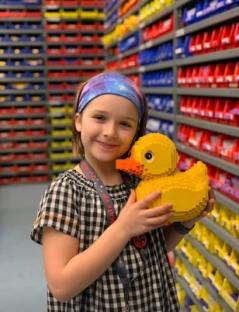 Girl holding a large Lego duck.