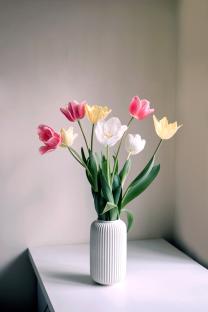 Bouquet of tulips in a white vase.