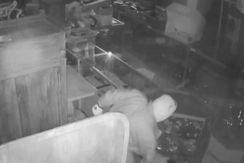 CCTV footage of a burglar stealing valuables from an auction house.