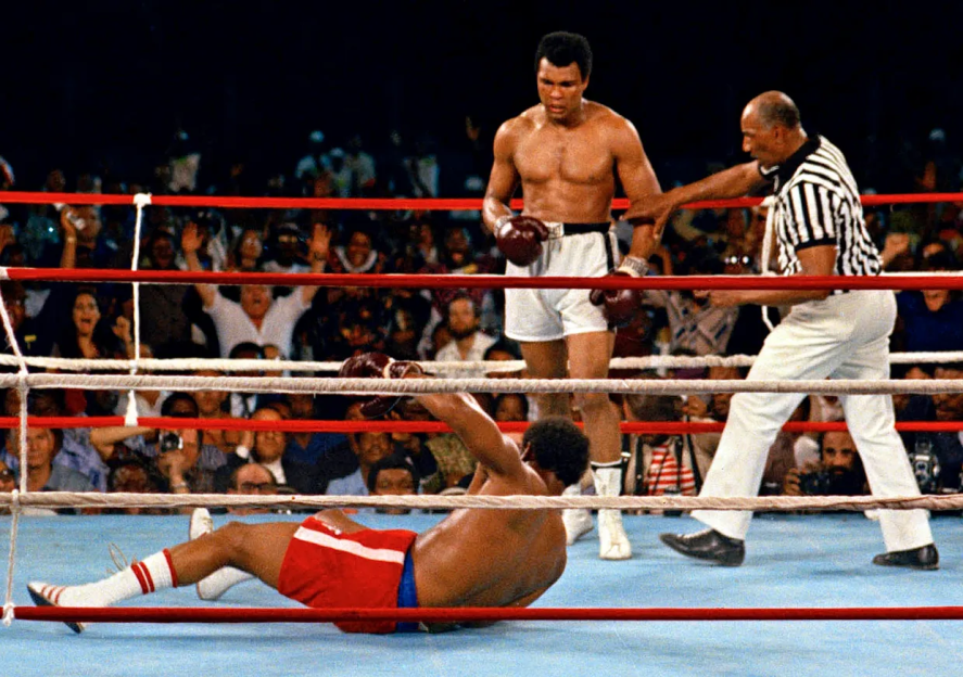 A boxer falls to the canvas during a boxing match.