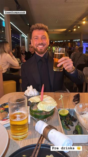 Sam Thompson raising a glass during pre-dinner drinks.