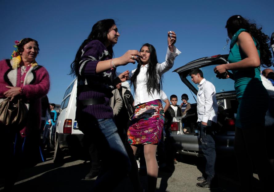 Roma brides-to-be dancing at a bridal market.