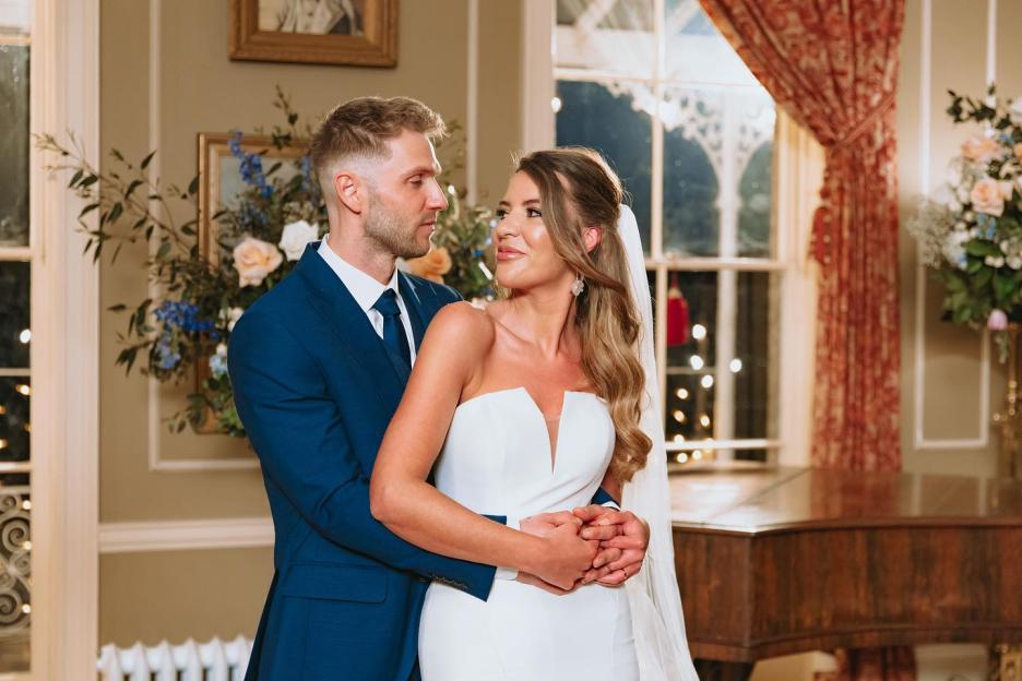 A bride and groom embrace on their wedding day.