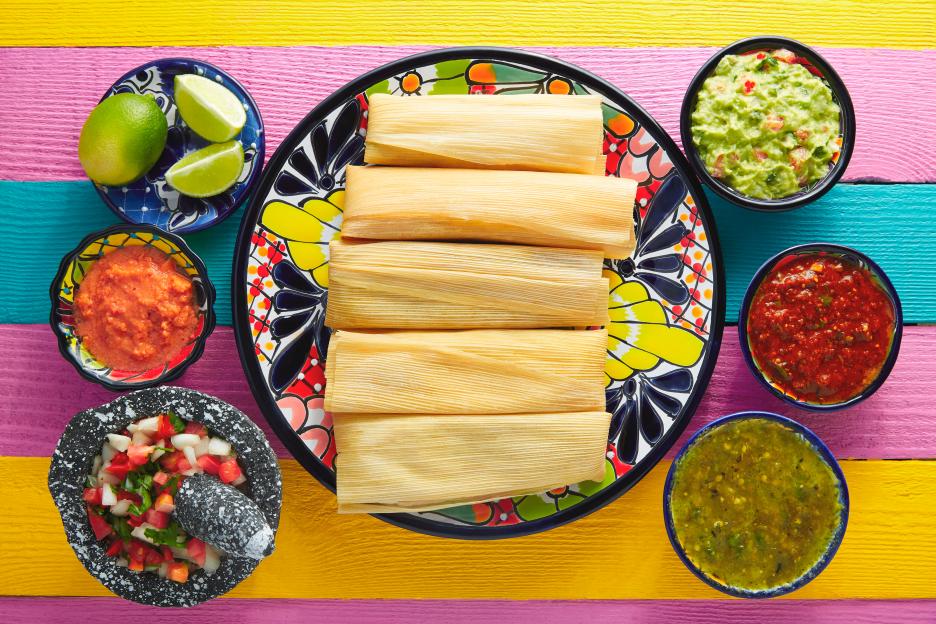 Tamales with various sauces and pico de gallo.