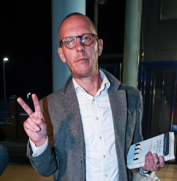 Laurence Fox leaving Croydon custody centre, giving a peace sign.