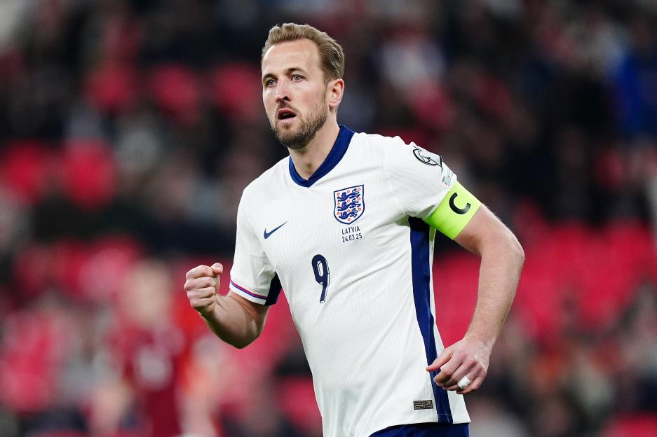 Harry Kane, wearing the England national team uniform, celebrates during a soccer match.