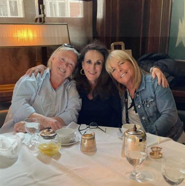 Three women enjoying a meal together.