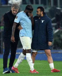 Nuno Tavares being comforted by his coach and teammate after an injury.