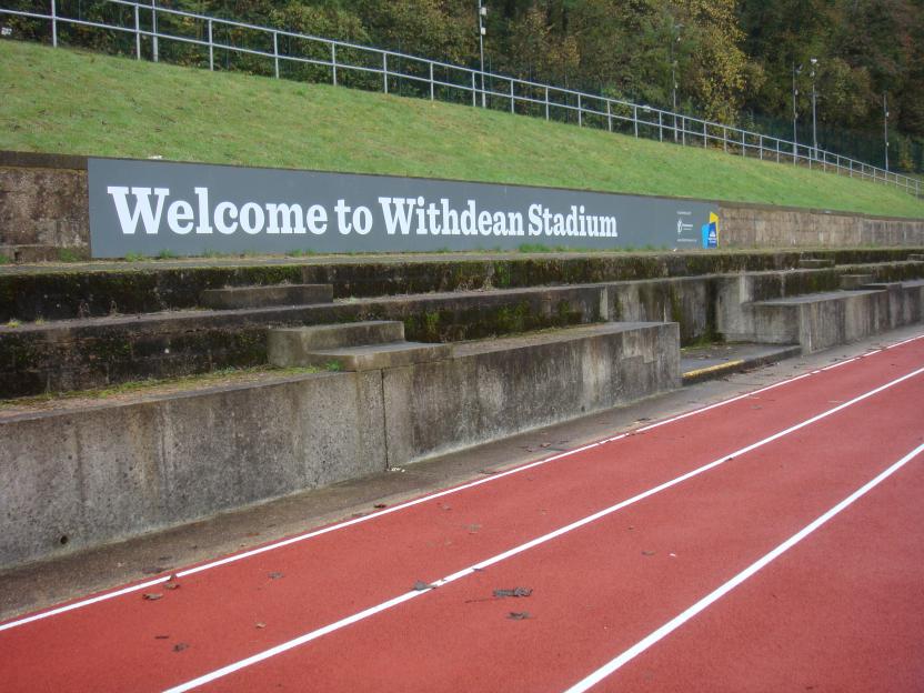 Welcome to Withdean Stadium sign at a running track.