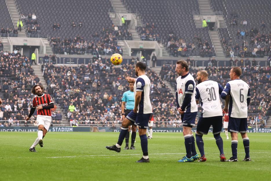 Andrea Pirlo kicking a soccer ball during a charity match.