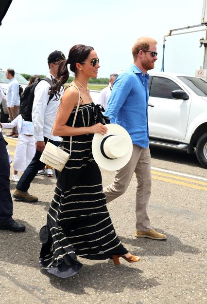 Meghan Markle and Prince Harry walking at an airport.