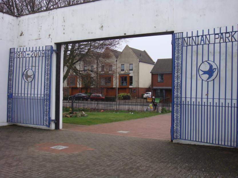 Entrance to Ninian Park, Cardiff, showing gates with the years 1910-2009 and a bird emblem.