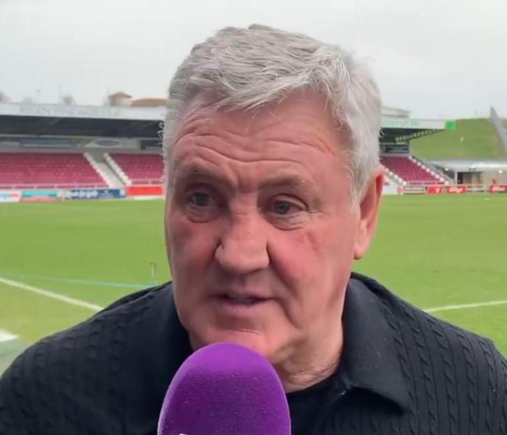 Man being interviewed at a soccer stadium.