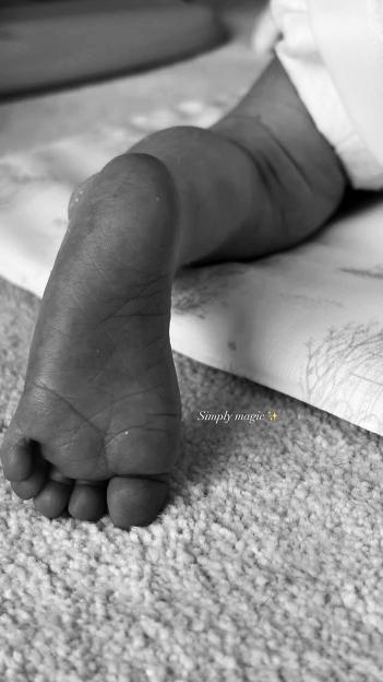 Black and white photo of a baby's foot.