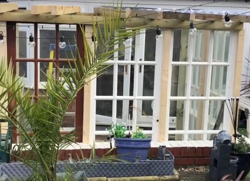 Garden shelter built from free Facebook Marketplace doors.