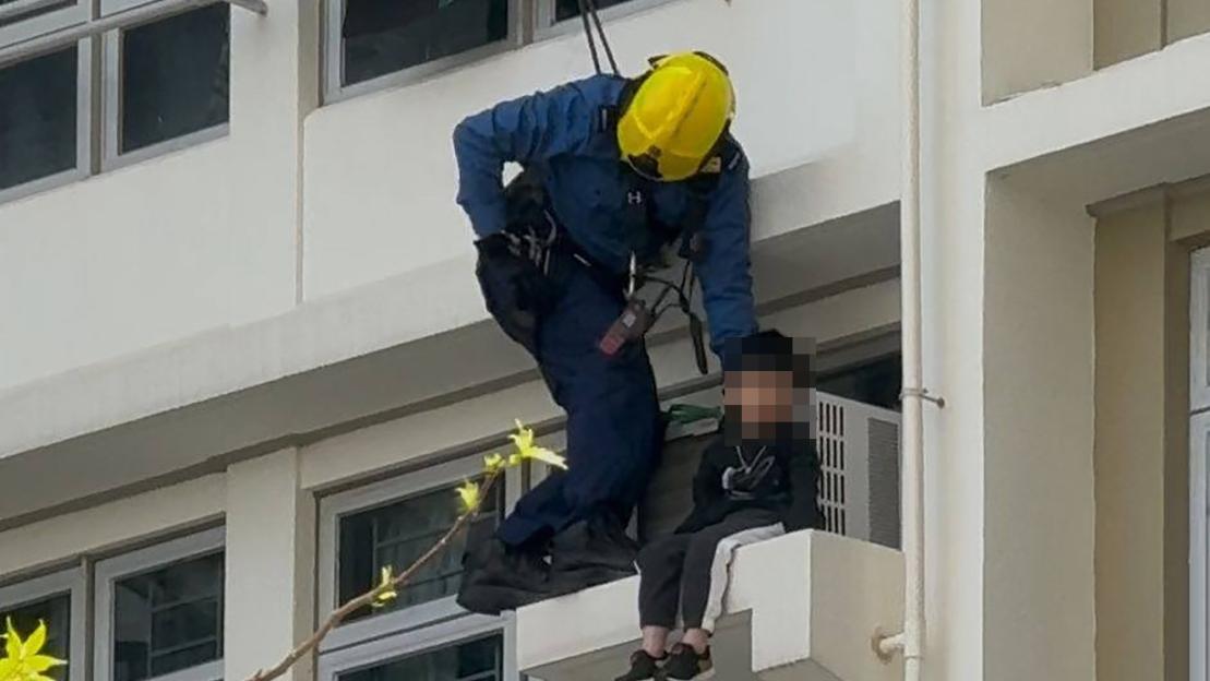 Watch nail-biting moment two terrified boys dangle on edge of high rise building after brothers are left home alone