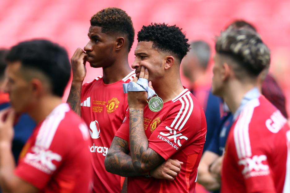 Jadon Sancho of Manchester United holding a runner-up medal.