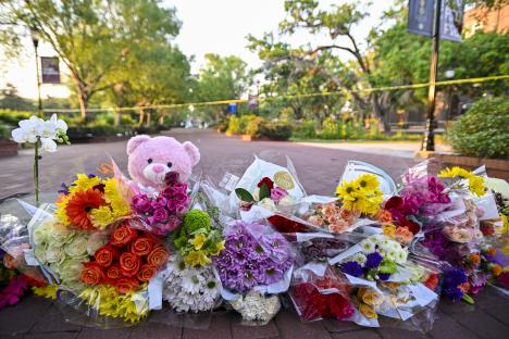 Memorial of flowers and a teddy bear at a Florida State University shooting scene.