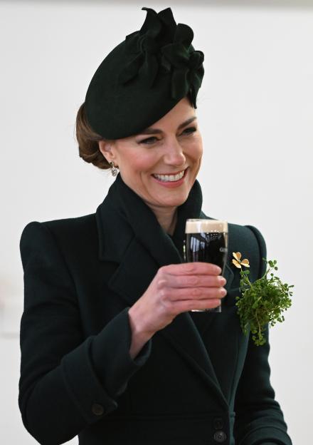 The Princess of Wales smiling and holding a glass of Guinness.