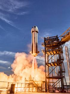 Blue Origin New Shepard rocket launching.