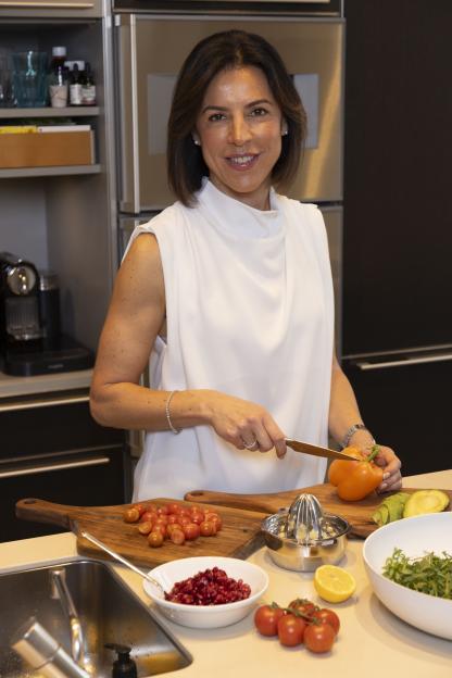 Woman preparing a healthy meal in her kitchen.