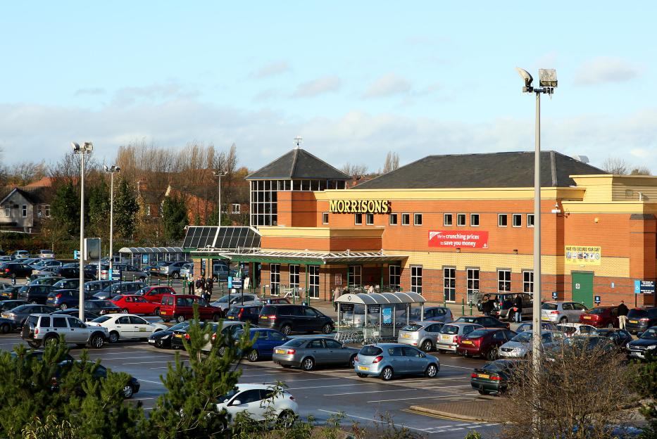 Morrisons supermarket with a full parking lot.