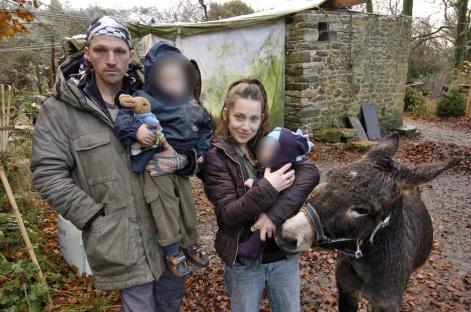 Theo Langton and Ruth McGill with their children and a donkey near their caravan.