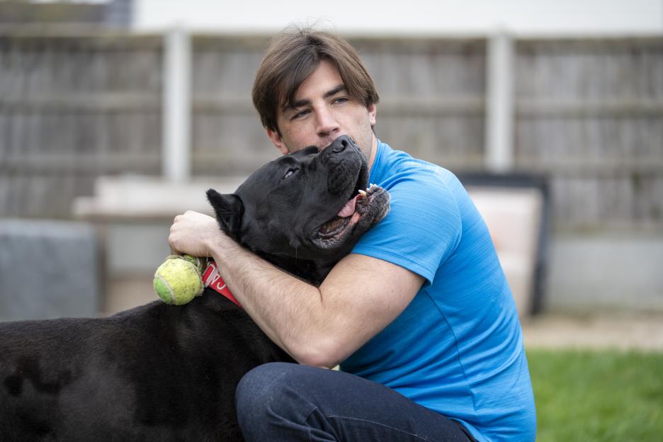 Man hugging his dog.