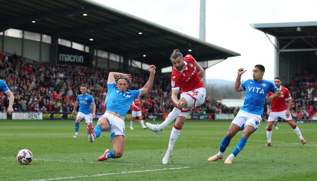 Jay RodrÃ­guez of Wrexham scoring a goal against Stockport County.