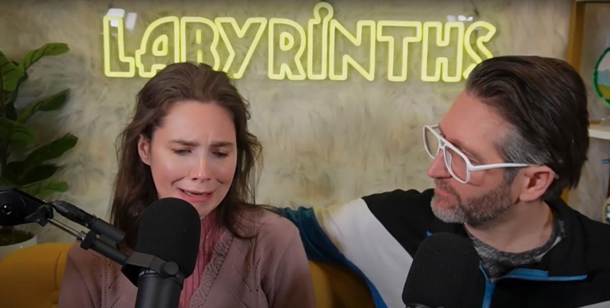 Amanda Knox crying during a podcast interview.