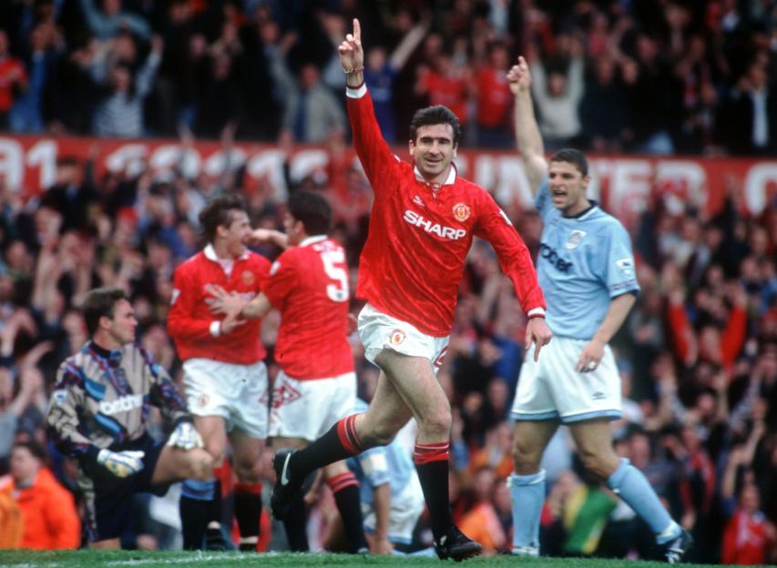 Eric Cantona of Manchester United celebrating a goal.