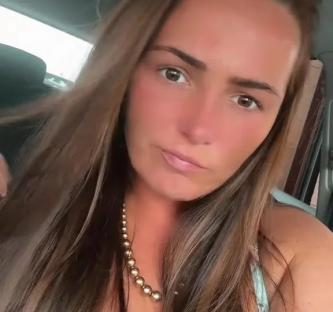Woman with long brown hair and a floral dress responds to a comment that says "Think again?"
