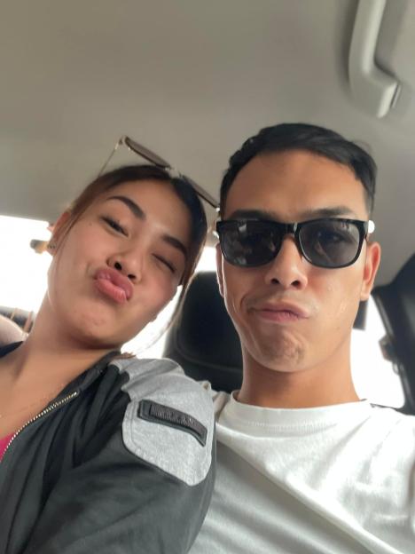 Close-up selfie of a young couple in a car.