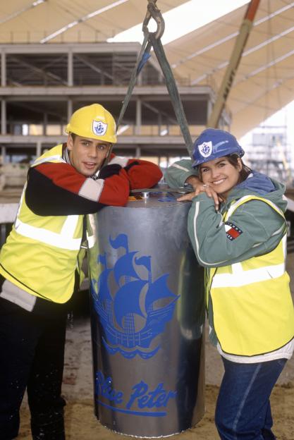 Katy Hill and Richard Bacon with a Blue Peter time capsule at the Millennium Dome.