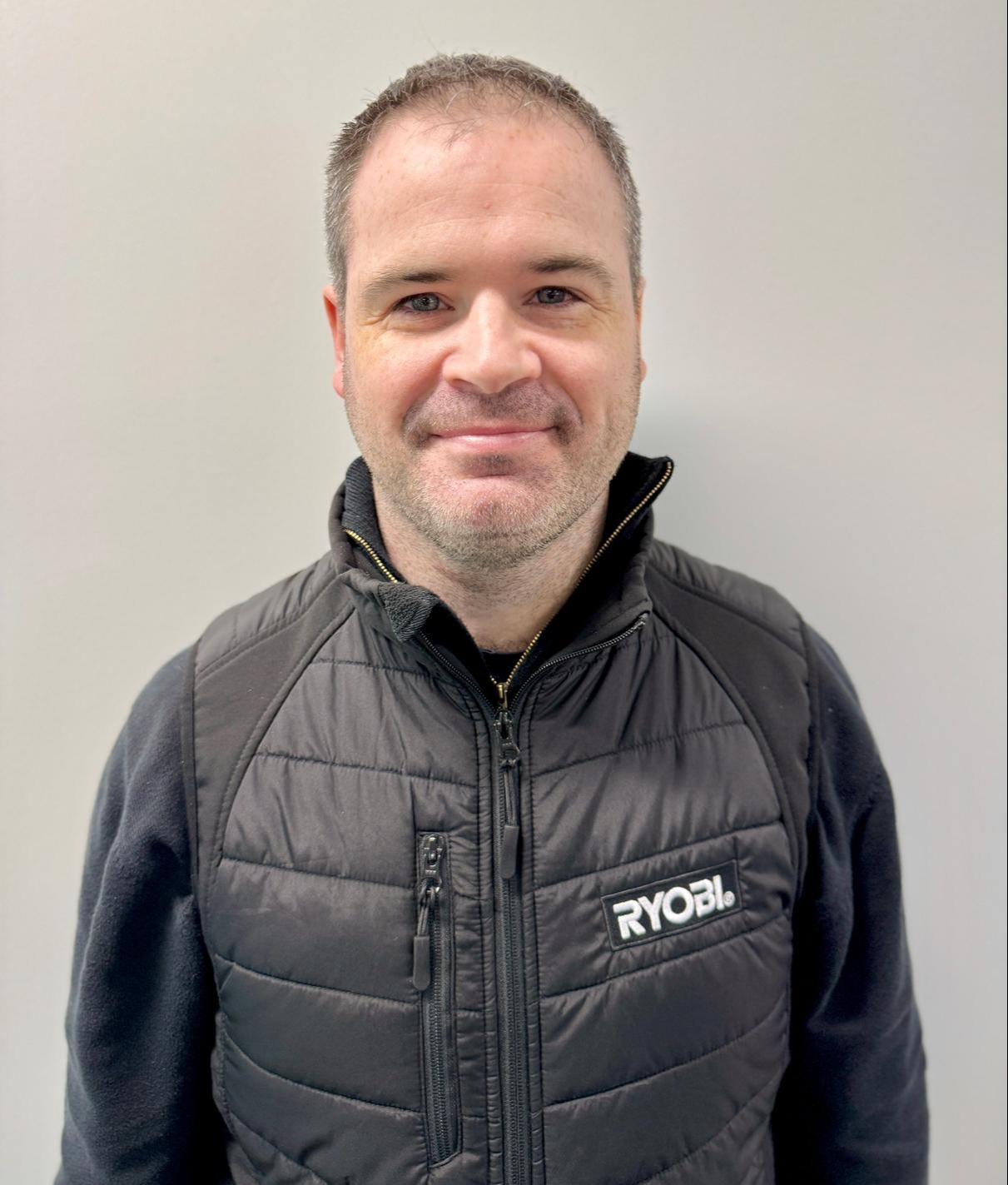 Headshot of a man wearing a black Ryobi vest.