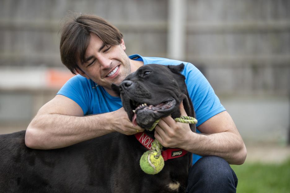 Man hugging his dog.