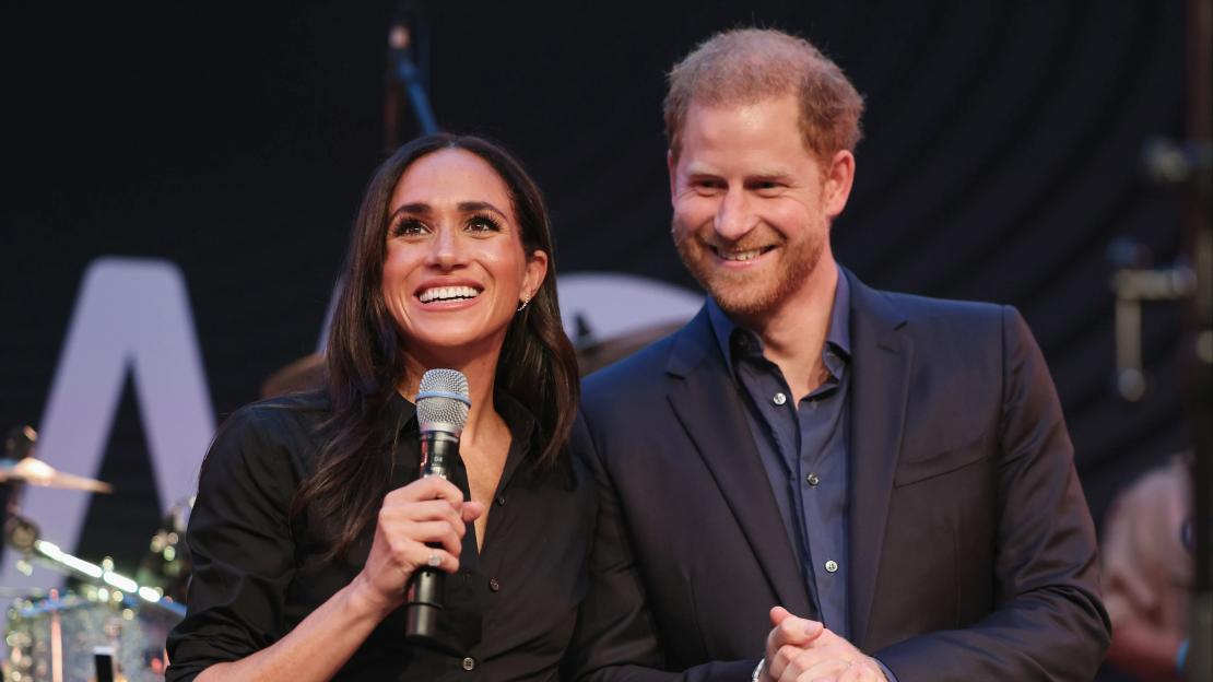 Prince Harry and Meghan Markle speaking at an event.