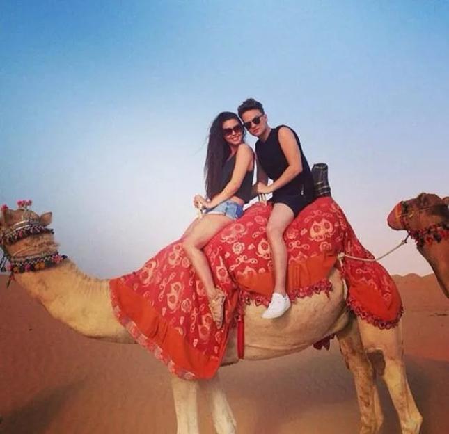 Victoria Tansey and Conor Maynard riding a camel.