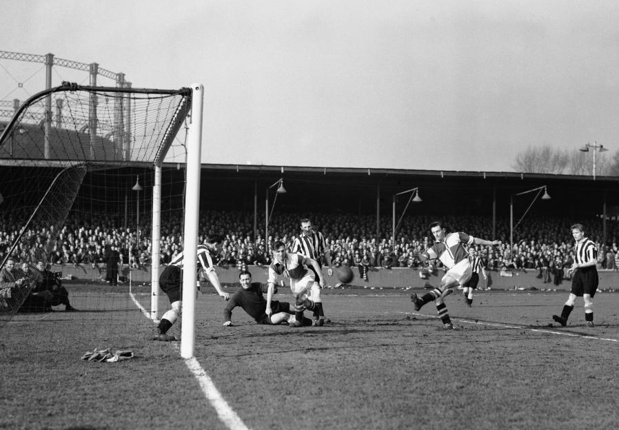 Black and white photo of a soccer game in progress.