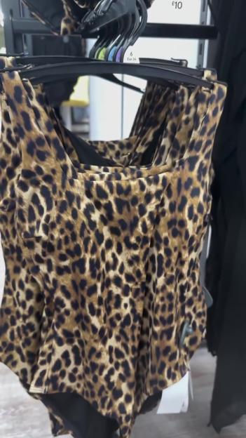 Leopard print swimsuits on hangers.